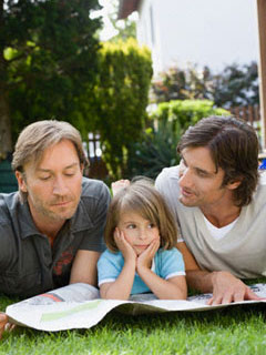 Photo:Two male parent with a child